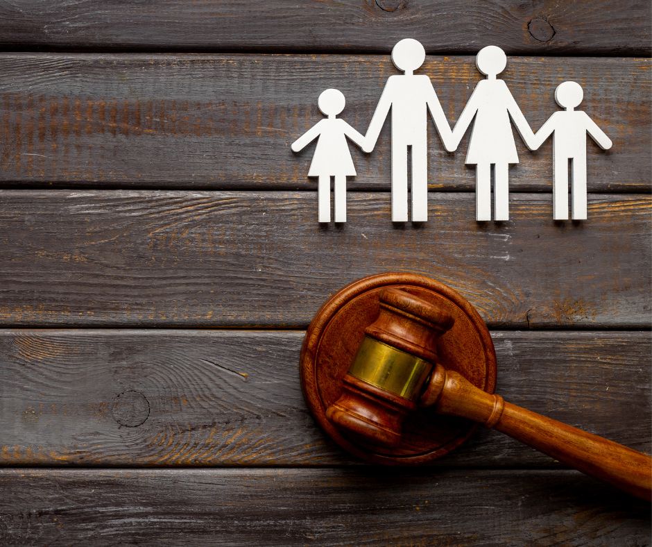 paper cutout of adoptive family with legal gavel