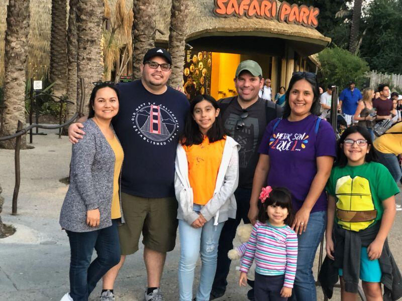 adoptive parents with hispanic family at safari park