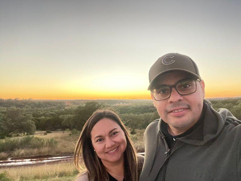 hispanic adoptive parents in front of sunset in austin, tx