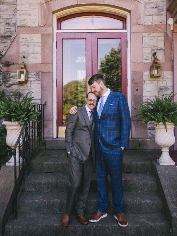 Ben and Eric, a gay couple that wants to adopt, being affectionate on the steps of an old building