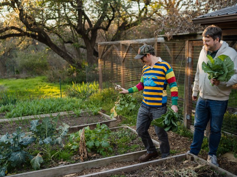 A gay, Jewish couple that wants to adopt a baby, tending to their backyard garden in Austin, TX.