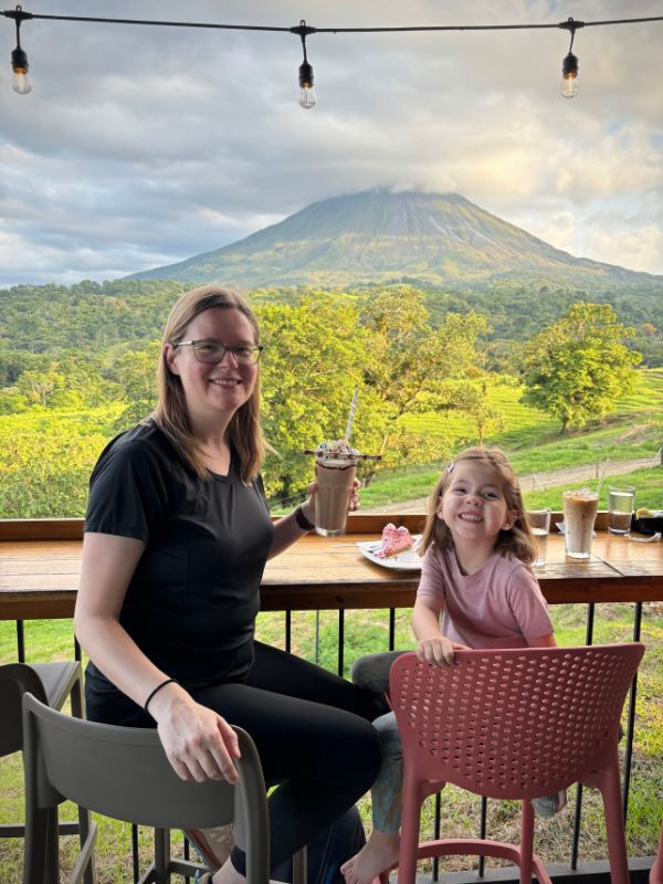 houston lgbt adoptive mom and daughter sharing a treat with a volcano in the background