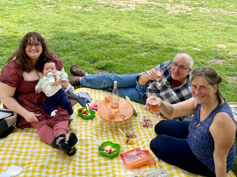 Amanda, part of a gay couple that wants to adopt, having a picnic with her parents and son