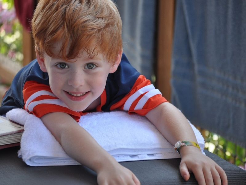 Red-headed boy posing with toys in portrait photo