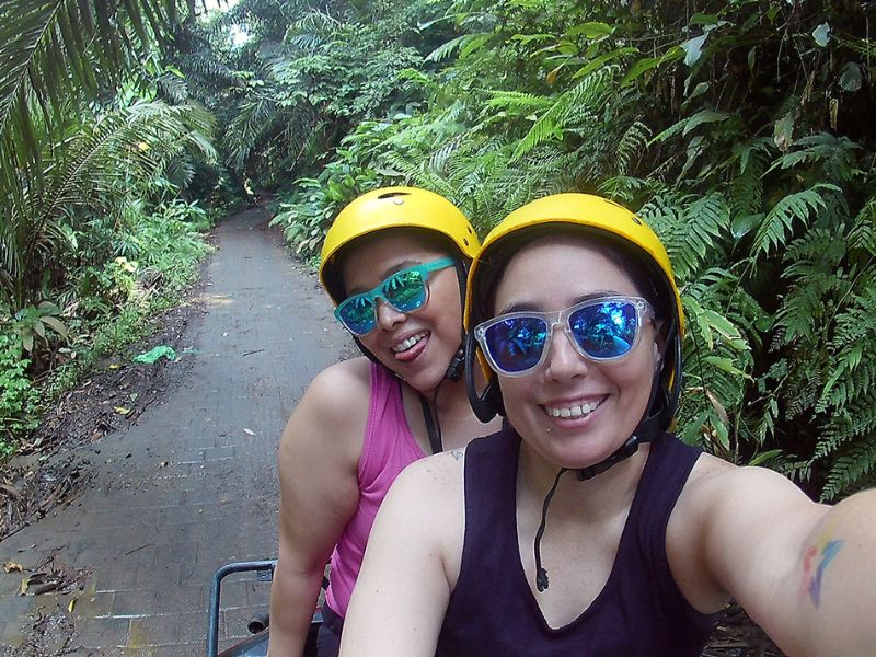 Cris and Sam, a gay couple that wants to adopt, on a bike in the jungle