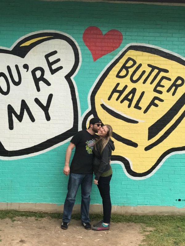 Prosepective adoptive parents in front of a mural in Austin, TX