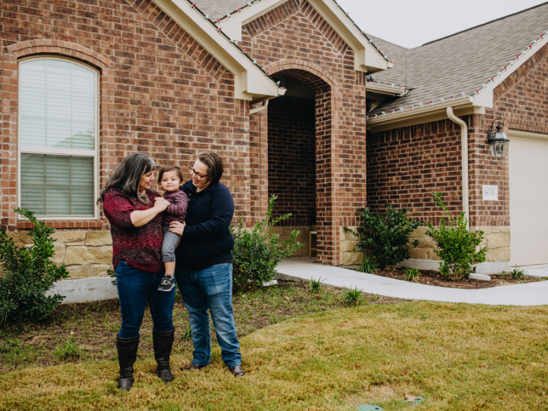 Jenny and Steph, a gay couple that wants to adopt, in front of their Austin-area house