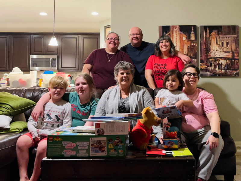 Jenny and Steph, an Austin, TX couple that wants to adopt a baby, in their home with their extended family