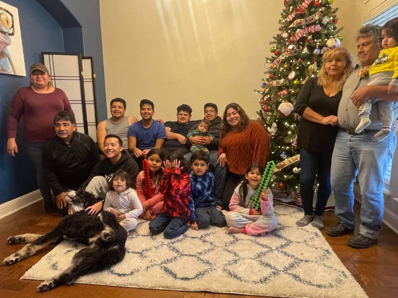 Gay couple that wants to adopt, holding nieces and smiling