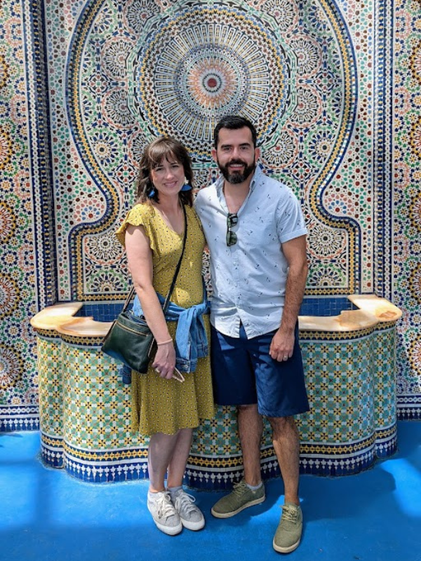 Pablo and Sabina, an Austin, TX couple that wants to adopt a baby, in front of a tiled fountain in mexico