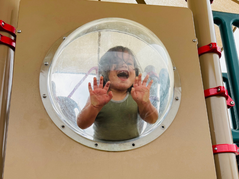 Adopted child of Jenny and Steph, playing on a playscape at a local park