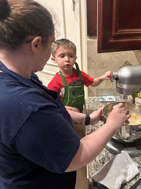 Adoptive mom baking with her young son