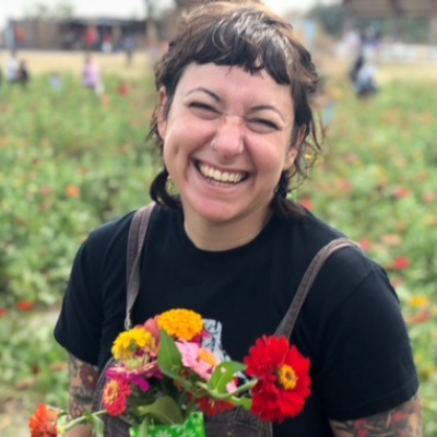 Katie, an Austin parent looking to adopt a baby, smiling with flowers