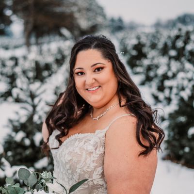 Brooke, a brown-haired adoptive mom in her wedding dress in the snow